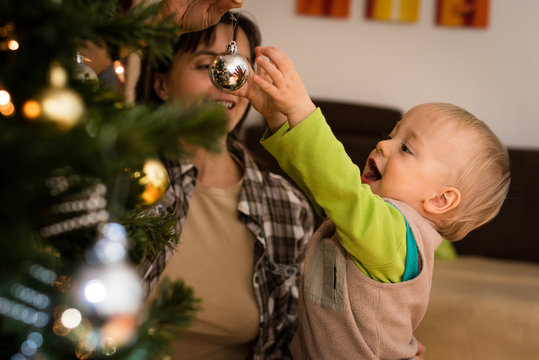 Joyous son playing with his mother indoors