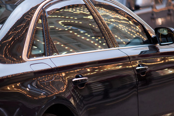 beautiful car with reflection of illumination on the surface