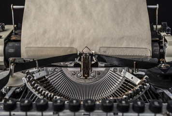 Vintage typewriter with an old blank sheet of paper mock up objects to accommodate your design.