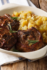 Lamb steak with rosemary and apple chutney close-up in a bowl. vertical