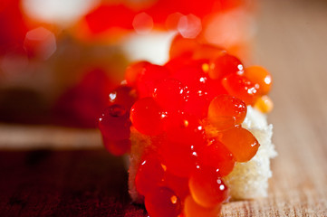 Red caviar with bread and butter on a dark background