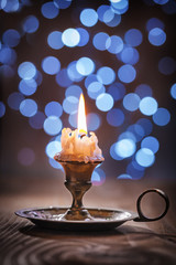 Fototapeta premium vintage candlestick with candle on blurred background