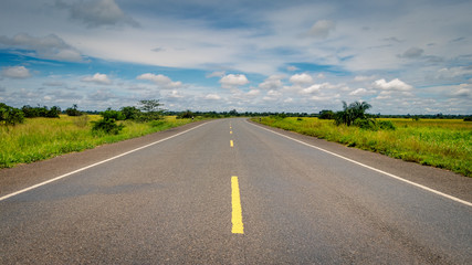 Empty endless highway through the Uganda landscape with copy space. This is the road between Mbale and Soroti and has been build by the Chinese.