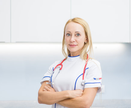 Portrait of a happy female doctor with arms crossed