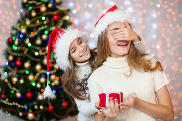 Girl surprising a mother with a Christmas present