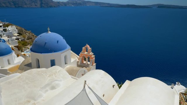 High angle view of blue dome church and boats on Aegean Sea in Santorini Island, Greece