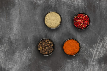 Fototapeta na wymiar Various pepper on a black background. Top view, copy space. Food background