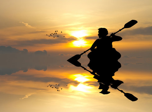 Man With A Kayak At Sunset