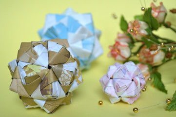 Modular origami, sonobe ball, on yellow background