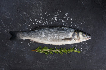 Seabass with rosemary and crystal salt on black backround