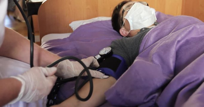 Nurse checking patient's blood pressure.