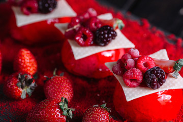 French berries mousse cake served on red sugar on wood background