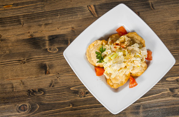 Fresh fried dumplings on bowl with salad on a wooden background. with copy space. top view