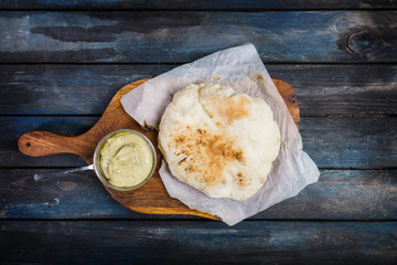 Traditional Middle east appetizer Hummus served with fresh pita bread. On a wooden board. Top view