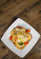 Fresh fried dumplings on bowl with salad on a wooden background. with copy space. top view