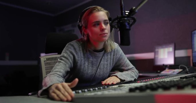 Female radio DJ in a recording studio