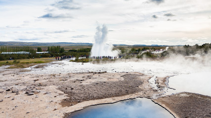 Strokkur geyser eruption and Geysir in Haukadalur