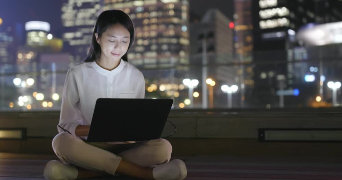 Woman use of notebook computer at night