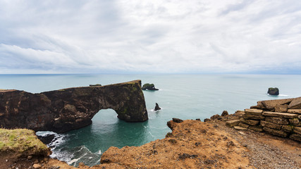 view of stone arch on Dyrholaey cliff in Iceland