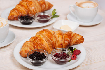 Tasty croissant served with fresh coffee