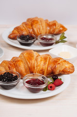 Tatsy croissants on the plate served with berry jam