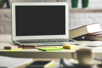 Modern table with empty laptop display