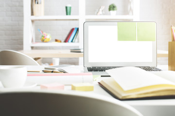 Modern workplace with white laptop screen