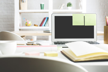 Bright workplace with white laptop screen