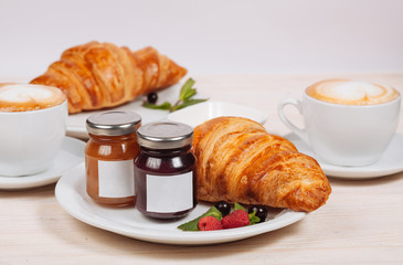 Sweet croissants served with cup of coffee
