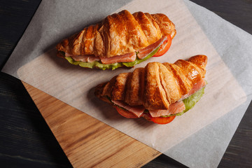 Top view of tasty croissants with salmon
