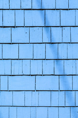 blue painted wooden shingles at the roof