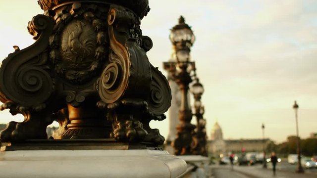 A detail of the famous Pont Alexandre III in Paris. Passengers are walking by watching the city. 