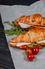 Close up of tasty croissants with tomatoes