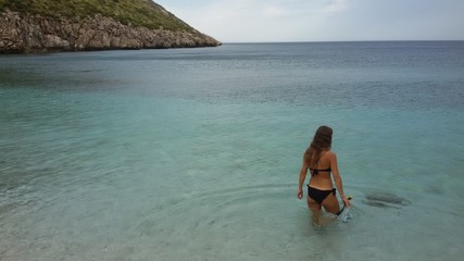 Obraz premium a girl explores the Zingaro nature reserve on Sicily island in Italy