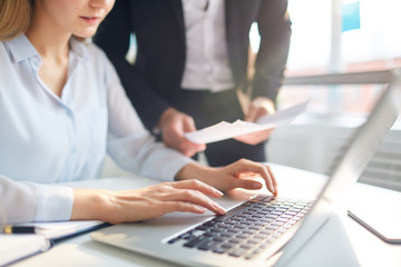 Obraz premium Businesswoman networking by desk on background of her colleague with paper