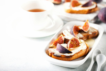 Bruschetta with figs, ricotta (cream cheese),  honey. Healthy food concept.  Top view.