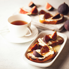 Bruschetta with figs, ricotta (cream cheese),  honey. Healthy food concept.  Top view.