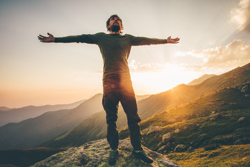 Traveler Man raised hands at sunset mountains Travel Lifestyle emotional concept adventure summer...