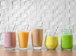 Different milkshakes in glassware on table
