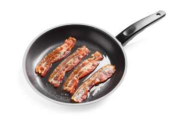 Frying pan with cooked bacon rashers on white background