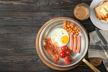 Composition with traditional English breakfast on table