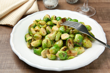 Plate with roasted brussel sprouts on table