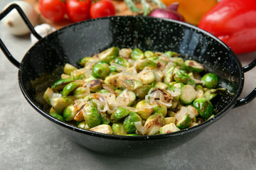 Dish with roasted brussel sprouts on table