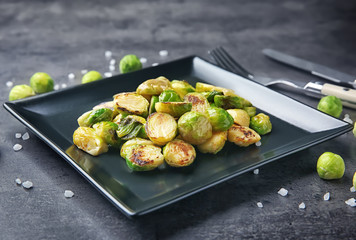 Plate with roasted brussel sprouts on table