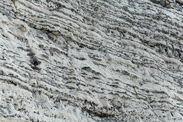 Layers of dark flint pebbles in limestone