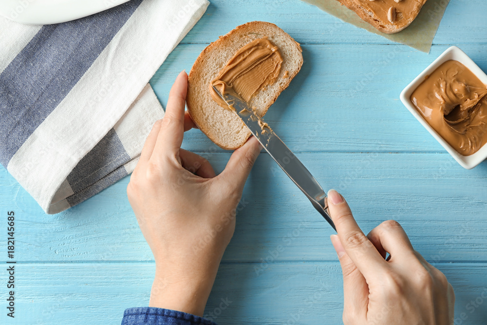 Sticker Woman spreading peanut butter on toast over table