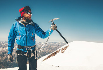 Man climber holding ice axe on mountain glacier Travel Lifestyle concept adventure active vacations extreme outdoor mountaineering sport using alpinism equipment - obrazy, fototapety, plakaty