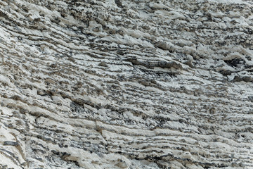 Layers of dark flint pebbles in limestone