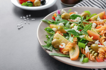 Plate with fresh vegetable salad on table, closeup