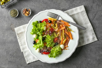 Plate with fresh vegetable salad on table